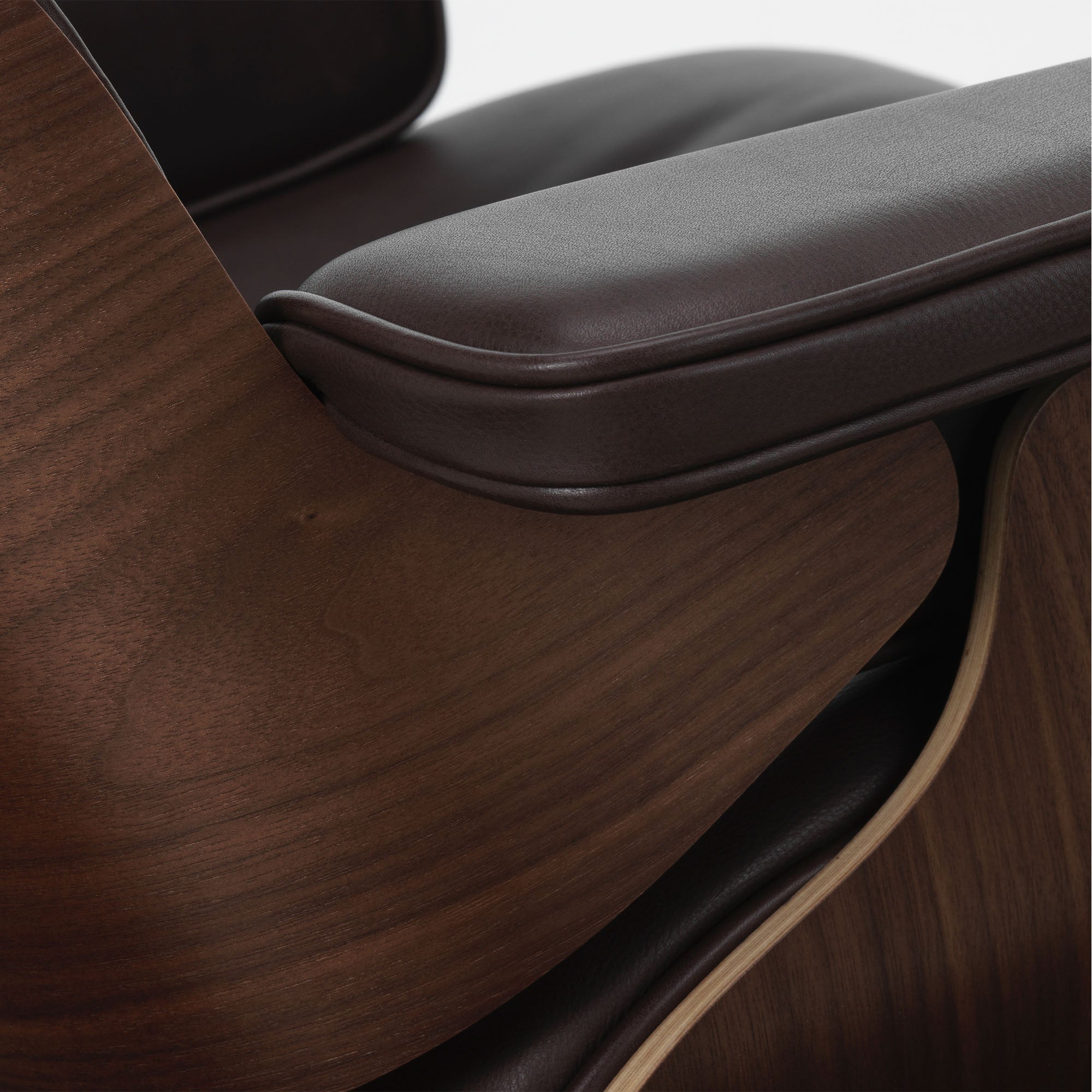 Eames Lounge Chair cu Otoman, lemn de nuc băițuit și bază satinată cu laterale negre