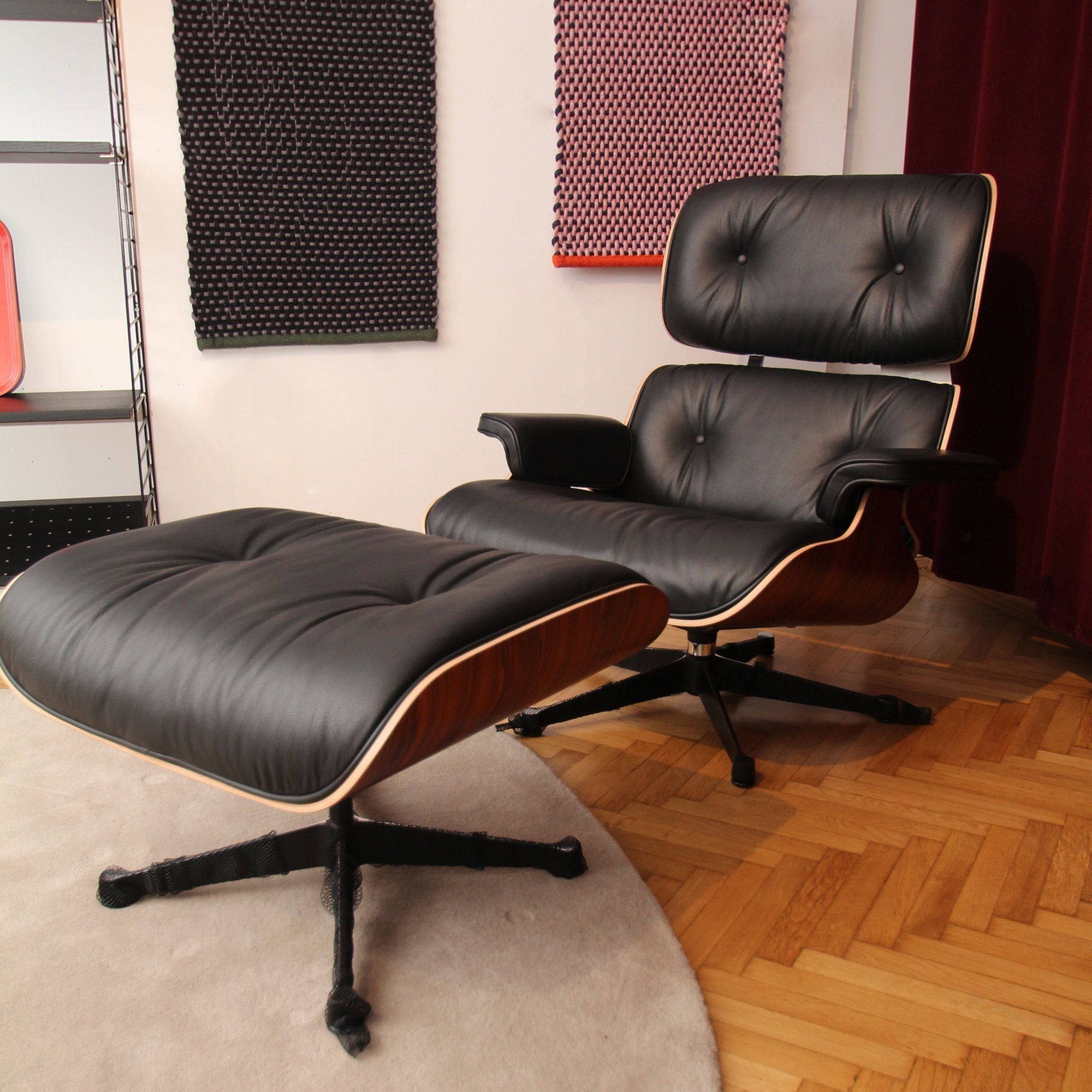 Eames Lounge Chair cu Otoman, lemn din palisandru și bază satinată cu laterale negre